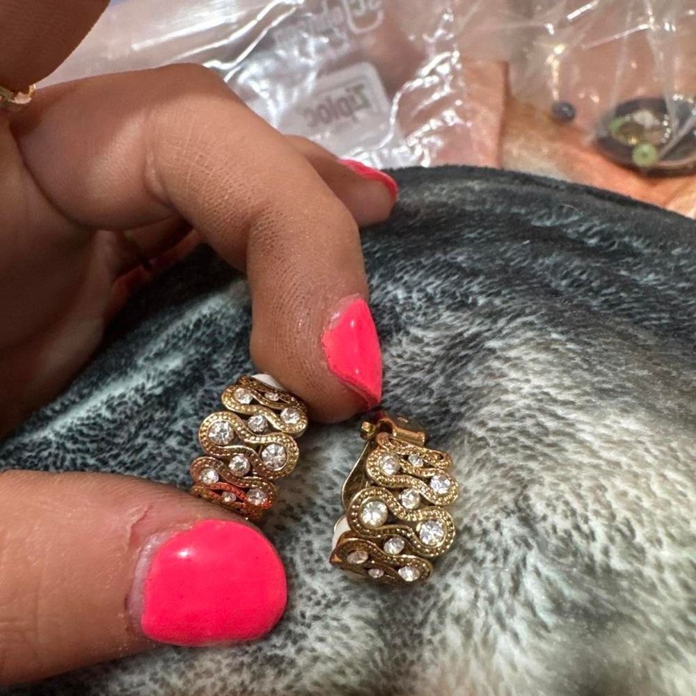 Gold earrings with clear rhinestones in a wavy design